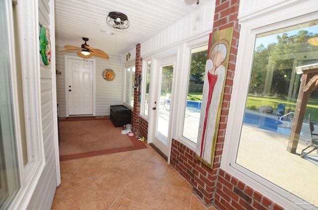 sunroom / solarium featuring ceiling fan and a wealth of natural light