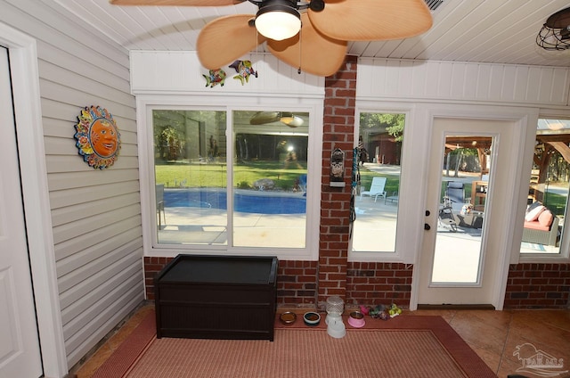 sunroom / solarium with a wealth of natural light and ceiling fan