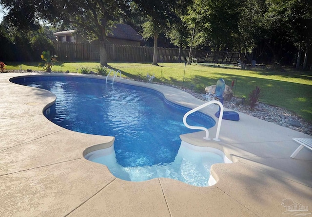 view of pool featuring a lawn and a patio