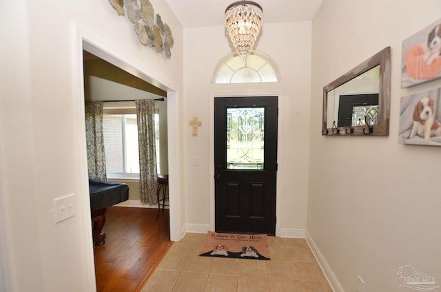 entrance foyer with a notable chandelier and light wood-type flooring