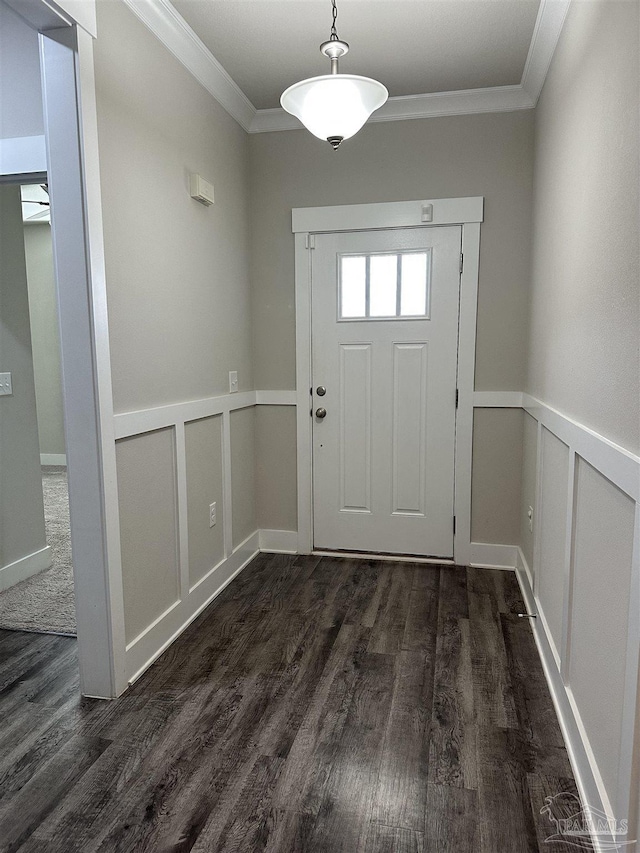 foyer with dark hardwood / wood-style flooring and crown molding