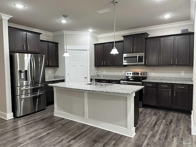 kitchen with decorative light fixtures, sink, appliances with stainless steel finishes, and light stone countertops