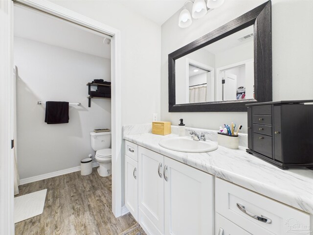430 Morris Ave, Cantonment, FL 32533 - bathroom with wood finished floors, baseboards, vanity, and toilet