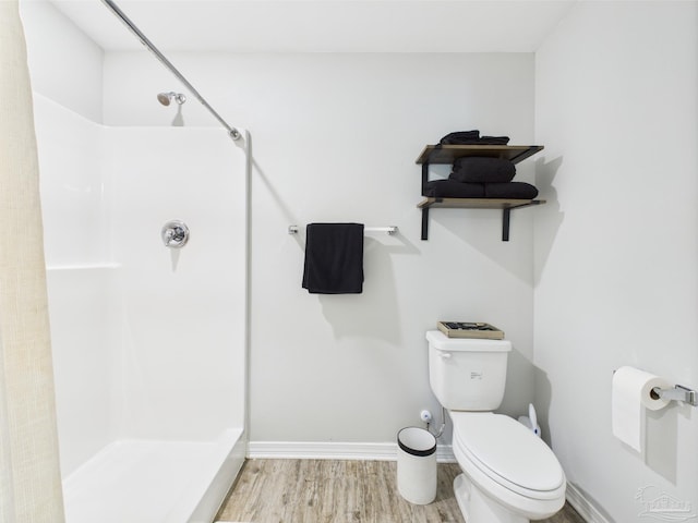 430 Morris Ave, Cantonment, FL 32533 - bathroom featuring a shower, wood finished floors, toilet, and baseboards