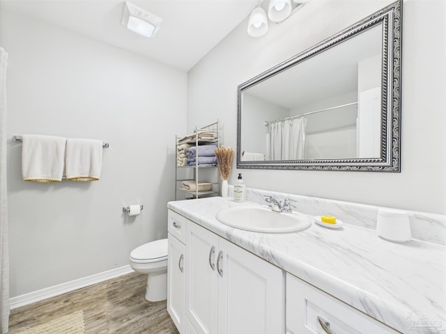 430 Morris Ave, Cantonment, FL 32533 - bathroom with wood finished floors, vanity, baseboards, toilet, and a shower with shower curtain