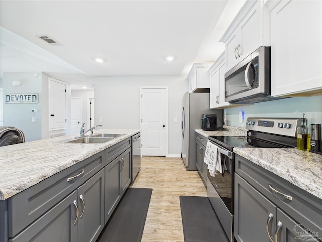 430 Morris Ave, Cantonment, FL 32533 - kitchen with stainless steel appliances, a sink, light wood-style floors, white cabinets, and recessed lighting