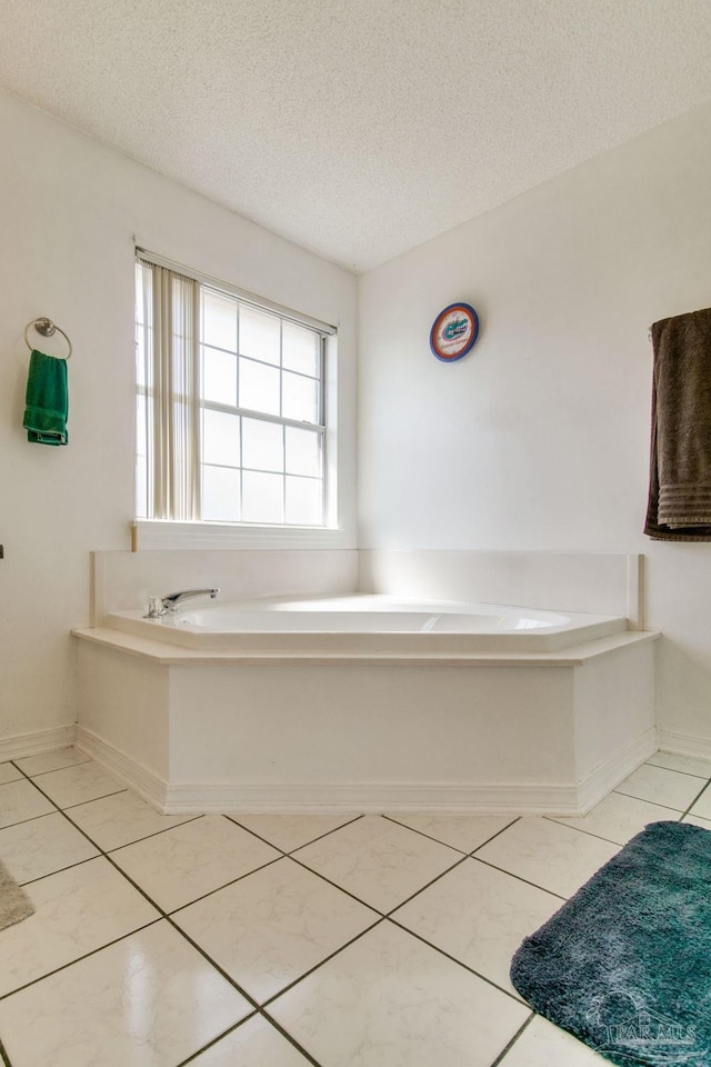 2405 Ursula Ln, Pensacola, FL 32526 - full bathroom featuring baseboards, tile patterned floors, a textured ceiling, and a garden tub