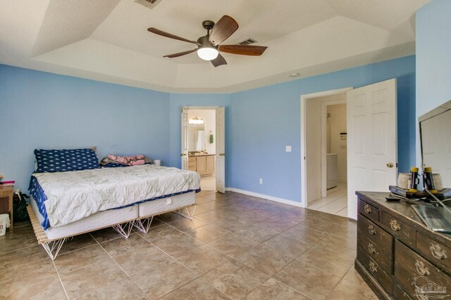 2405 Ursula Ln, Pensacola, FL 32526 - bedroom with ensuite bathroom, visible vents, light tile patterned floors, ceiling fan, and a tray ceiling