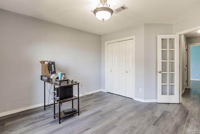 2405 Ursula Ln, Pensacola, FL 32526 - bedroom featuring visible vents, baseboards, a closet, wood finished floors, and french doors