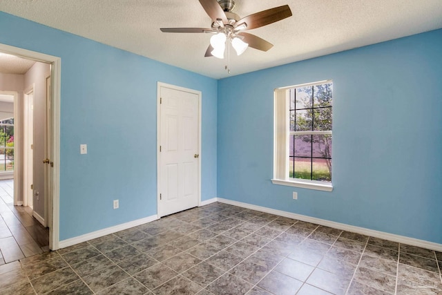 2405 Ursula Ln, Pensacola, FL 32526 - unfurnished room with baseboards, a ceiling fan, and a textured ceiling