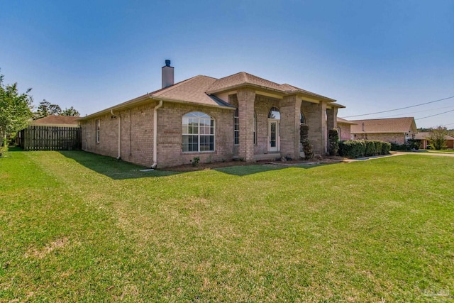 2405 Ursula Ln, Pensacola, FL 32526 - back of house featuring brick siding, fence, a lawn, and a chimney