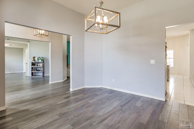 2405 Ursula Ln, Pensacola, FL 32526 - unfurnished dining area featuring wood finished floors, an inviting chandelier, and baseboards