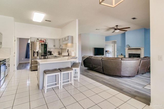 2405 Ursula Ln, Pensacola, FL 32526 - kitchen featuring visible vents, a sink, light wood-type flooring, a kitchen bar, and stainless steel appliances