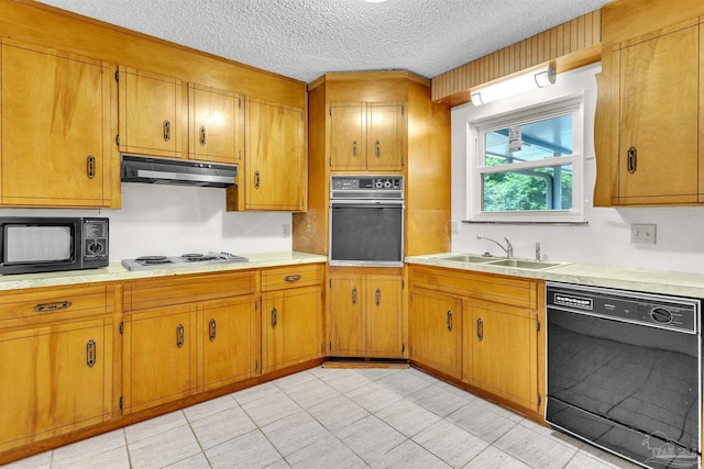 465 Man O War Cir, Cantonment, FL 32533 - kitchen with black appliances, under cabinet range hood, light countertops, brown cabinetry, and a textured ceiling