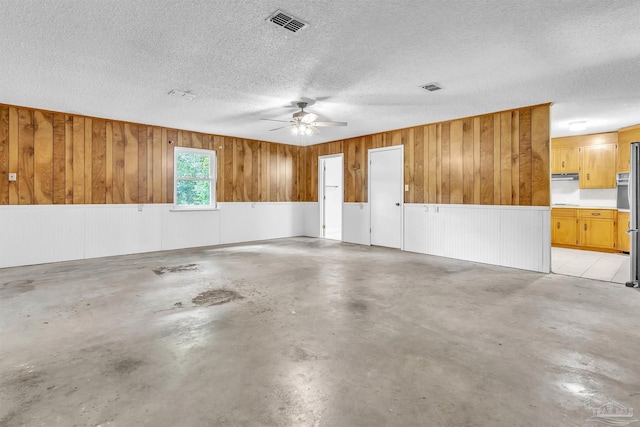 465 Man O War Cir, Cantonment, FL 32533 - garage featuring ceiling fan, wood walls, and fridge