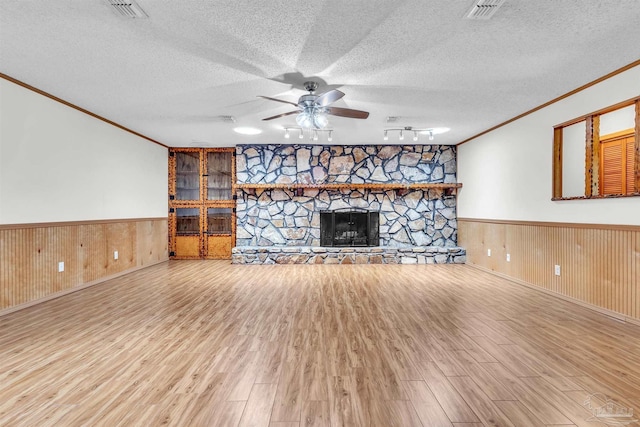 465 Man O War Cir, Cantonment, FL 32533 - unfurnished living room featuring ornamental molding, wainscoting, wood finished floors, ceiling fan, and a textured ceiling