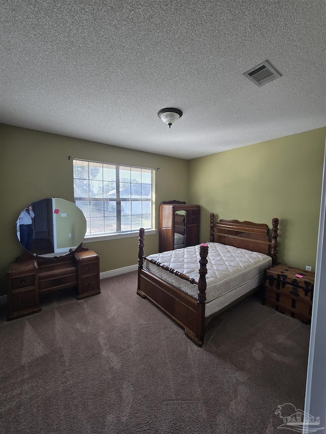 carpeted bedroom with a textured ceiling