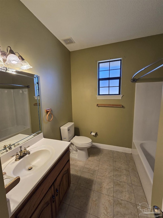 bathroom featuring tile patterned flooring, vanity, a textured ceiling, and toilet