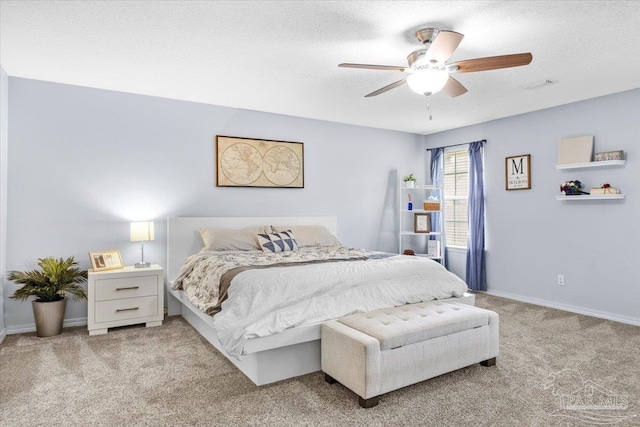 carpeted bedroom featuring a textured ceiling, ceiling fan, visible vents, and baseboards