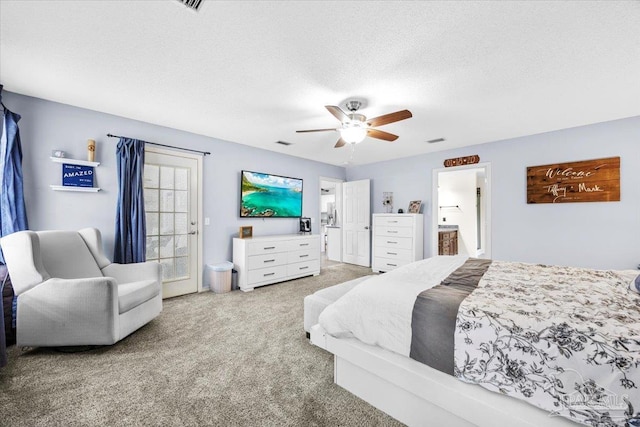 carpeted bedroom featuring visible vents, ceiling fan, and a textured ceiling