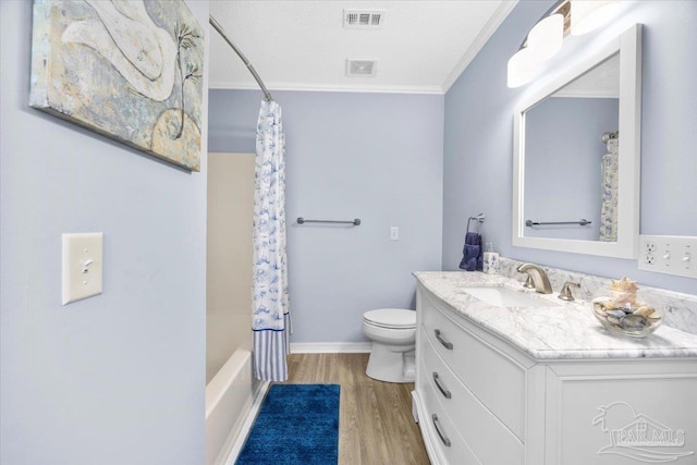 full bathroom featuring toilet, vanity, wood finished floors, and visible vents