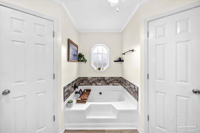 full bathroom featuring crown molding and a bath