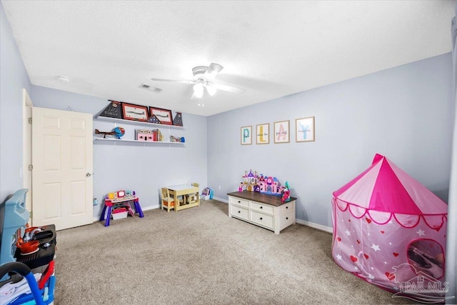 rec room with carpet, visible vents, ceiling fan, a textured ceiling, and baseboards