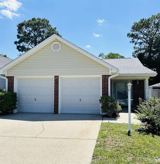 ranch-style home featuring a garage, brick siding, concrete driveway, and a shingled roof