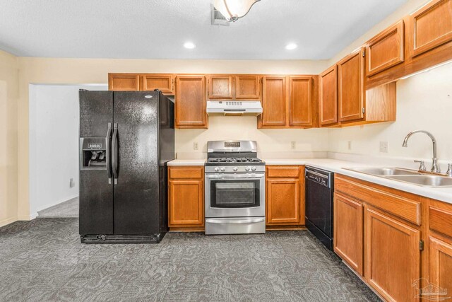 kitchen featuring dark carpet, black appliances, a textured ceiling, and sink