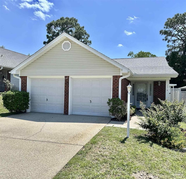 ranch-style home featuring driveway, brick siding, and an attached garage