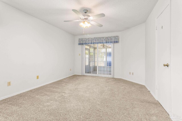 carpeted empty room with a textured ceiling and ceiling fan