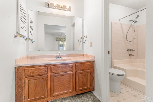 full bathroom with vanity, toilet, ceiling fan, and tub / shower combination