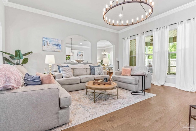2120 Eagles Ridge Cv, Cantonment, FL 32533 - living room with a chandelier, arched walkways, wood finished floors, and ornamental molding