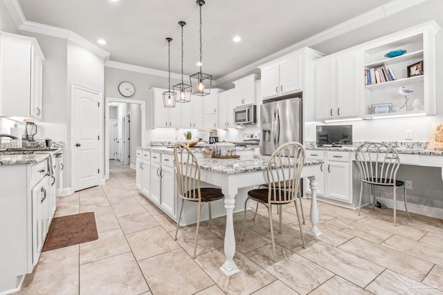 2120 Eagles Ridge Cv, Cantonment, FL 32533 - kitchen with stainless steel appliances, crown molding, white cabinets, a center island, and light stone countertops