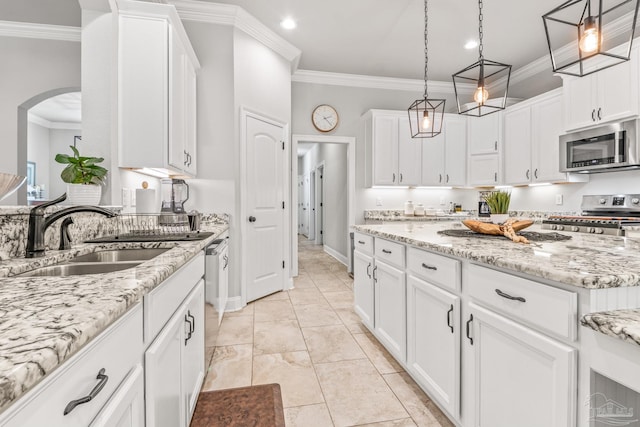 2120 Eagles Ridge Cv, Cantonment, FL 32533 - kitchen with stainless steel appliances, a sink, crown molding, arched walkways, and white cabinetry