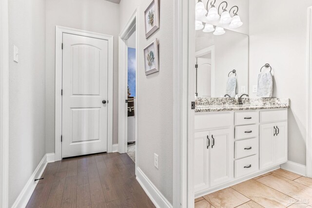 2120 Eagles Ridge Cv, Cantonment, FL 32533 - bathroom with hardwood / wood-style floors, baseboards, and vanity