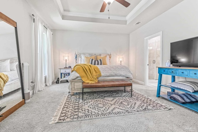 2120 Eagles Ridge Cv, Cantonment, FL 32533 - carpeted bedroom with a tray ceiling, connected bathroom, a ceiling fan, ornamental molding, and baseboards