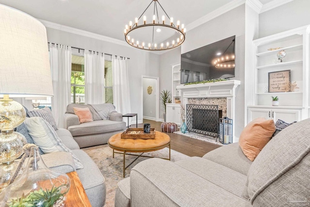 2120 Eagles Ridge Cv, Cantonment, FL 32533 - living room featuring crown molding, baseboards, built in shelves, a chandelier, and wood finished floors