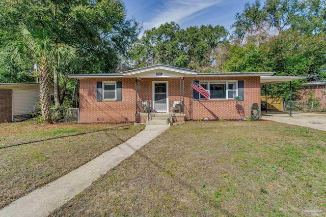 ranch-style house featuring a carport and a front lawn