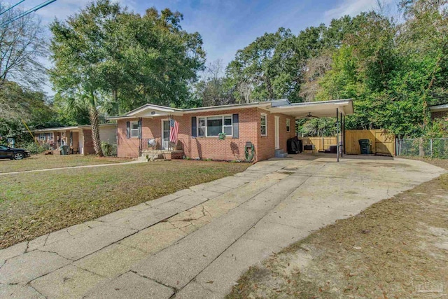 ranch-style house featuring a carport and a front yard