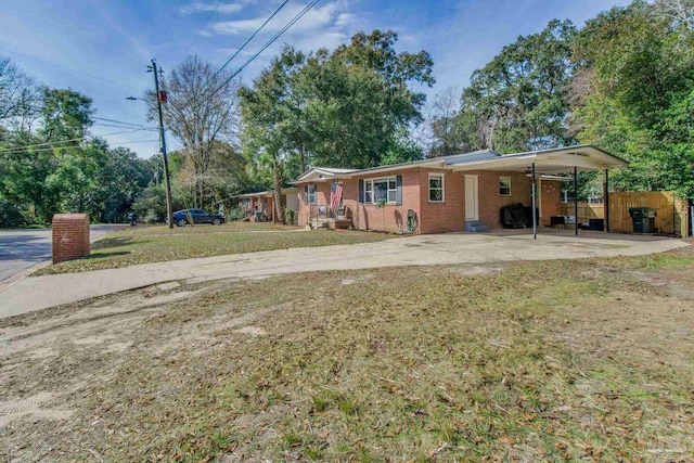 exterior space featuring a carport and a front yard