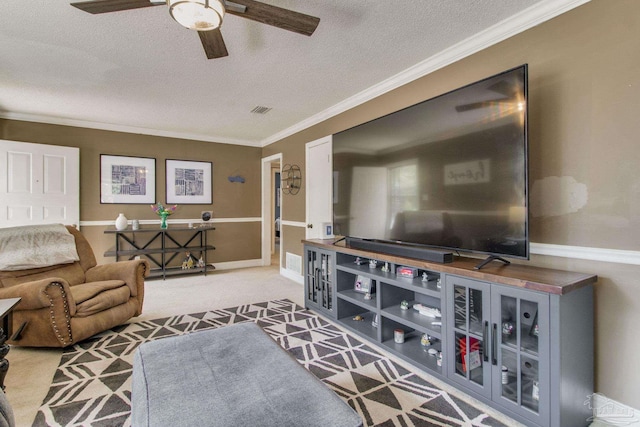 living room featuring crown molding, carpet floors, ceiling fan, and a textured ceiling