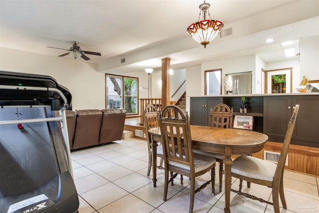 dining space with light tile patterned floors, stairway, and visible vents