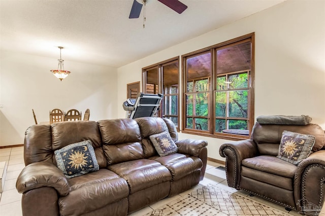 living room featuring ceiling fan, baseboards, and light tile patterned flooring