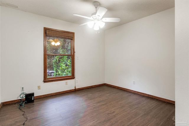 empty room with wood finished floors, ceiling fan, and baseboards