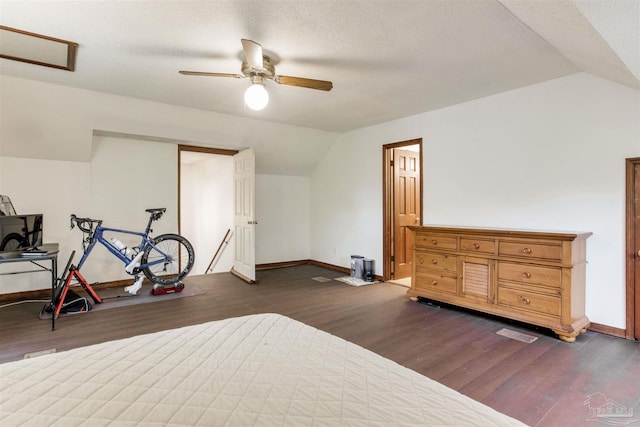 bedroom featuring dark wood finished floors, a ceiling fan, baseboards, and lofted ceiling