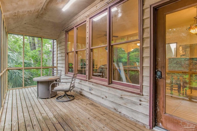 sunroom / solarium featuring vaulted ceiling and hardwood / wood-style flooring