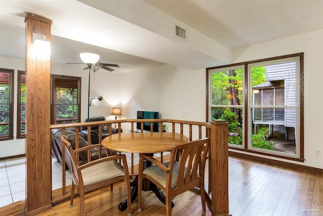 dining space featuring light wood-style flooring, visible vents, baseboards, and a ceiling fan