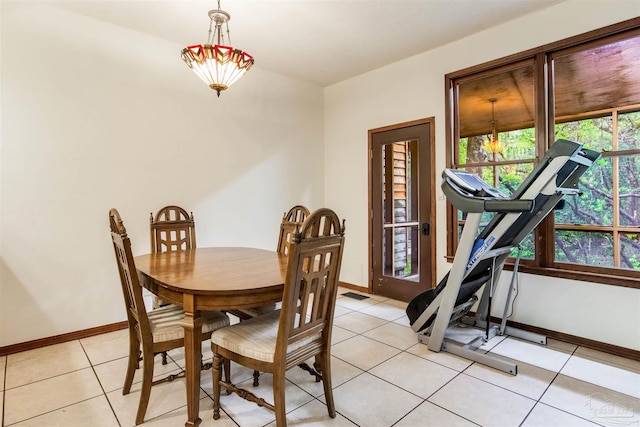 dining space featuring light tile patterned floors, baseboards, and visible vents