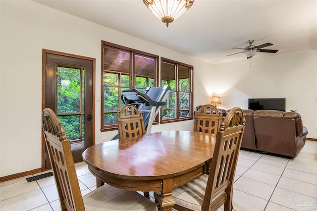 dining room with light tile patterned floors, baseboards, a ceiling fan, and visible vents
